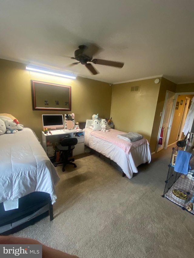 carpeted bedroom with ceiling fan and crown molding