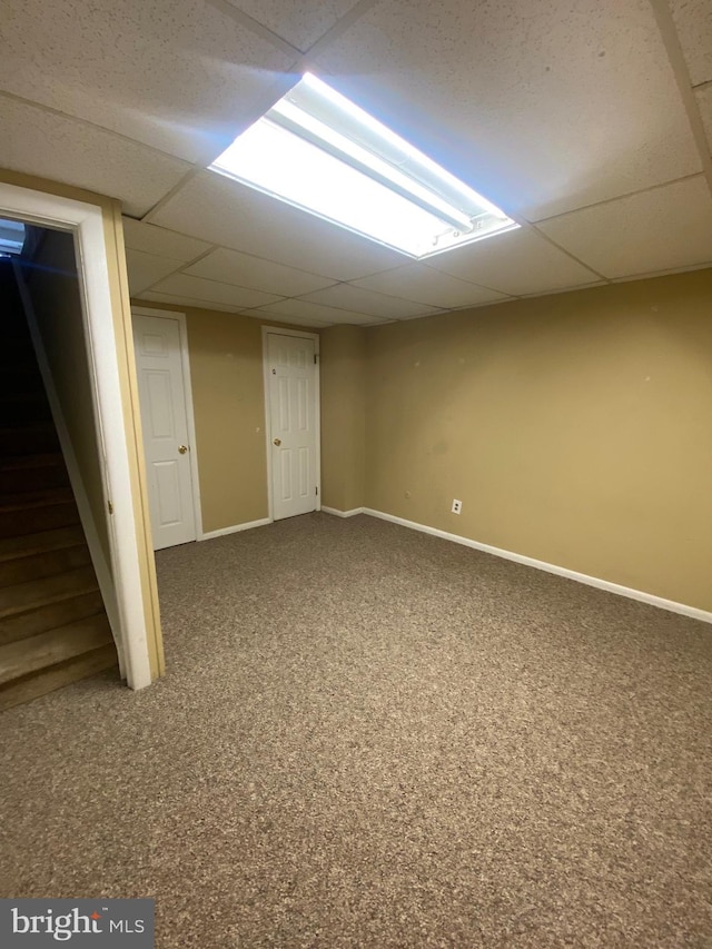 basement featuring carpet and a drop ceiling