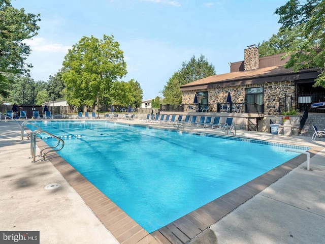 view of swimming pool featuring a patio area