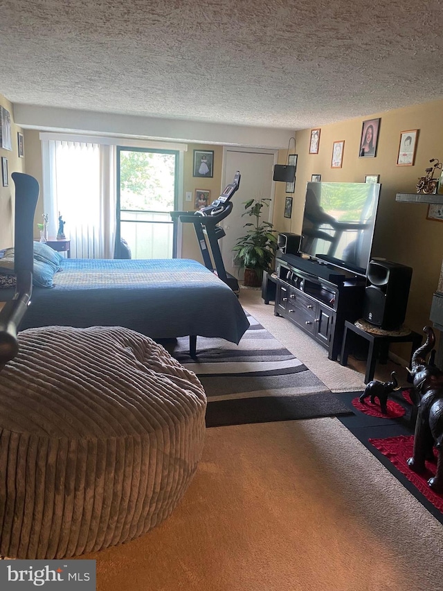 bedroom featuring carpet floors and a textured ceiling