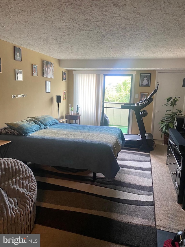 carpeted bedroom featuring a textured ceiling