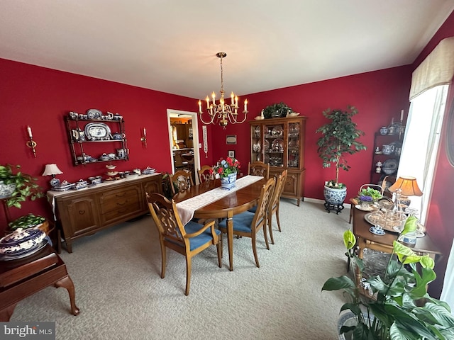 dining room with a notable chandelier and carpet flooring