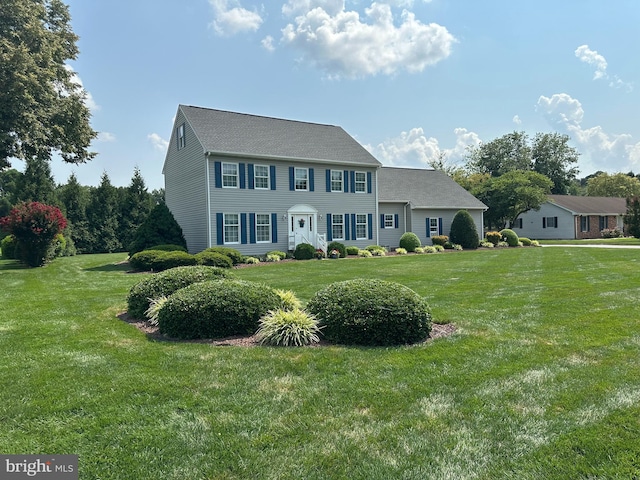 colonial home featuring a front yard