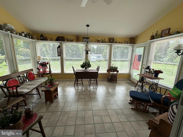 sunroom / solarium with ceiling fan and lofted ceiling