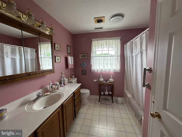 full bathroom with tile patterned floors, shower / bath combo, toilet, and vanity