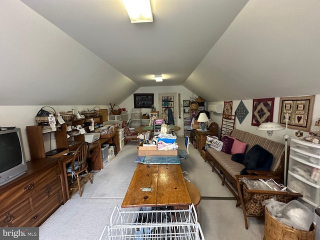 interior space featuring vaulted ceiling and light colored carpet