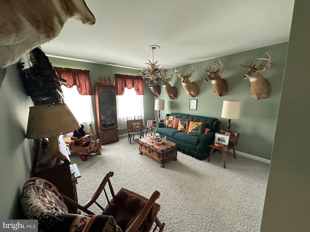 living room with an inviting chandelier and carpet floors