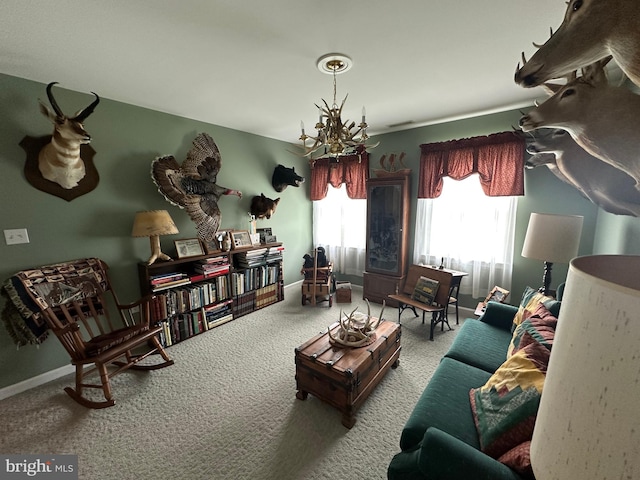 carpeted living room with a chandelier