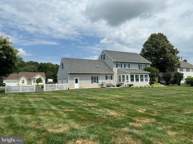 rear view of house with a lawn