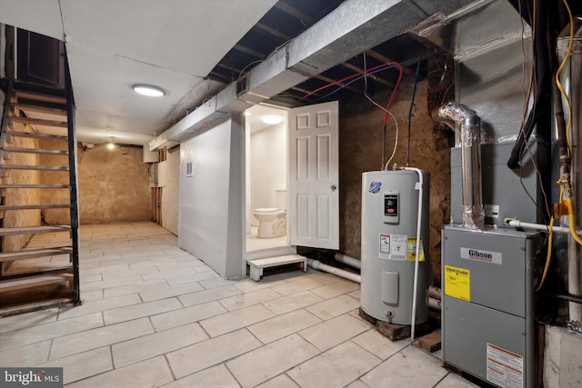 basement with heating unit, water heater, and light tile patterned floors