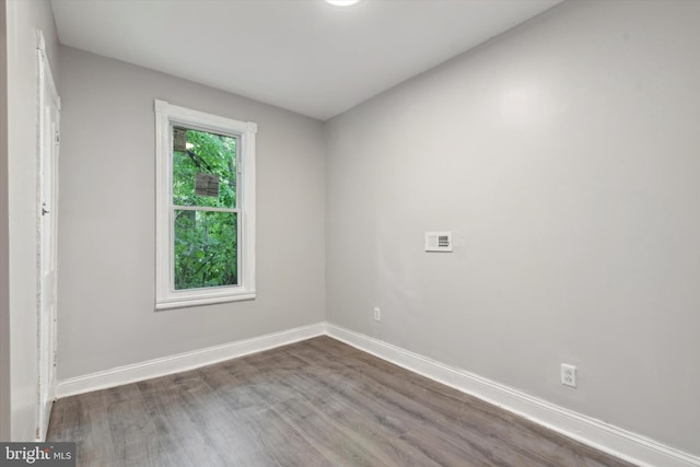 spare room featuring hardwood / wood-style flooring and a wealth of natural light