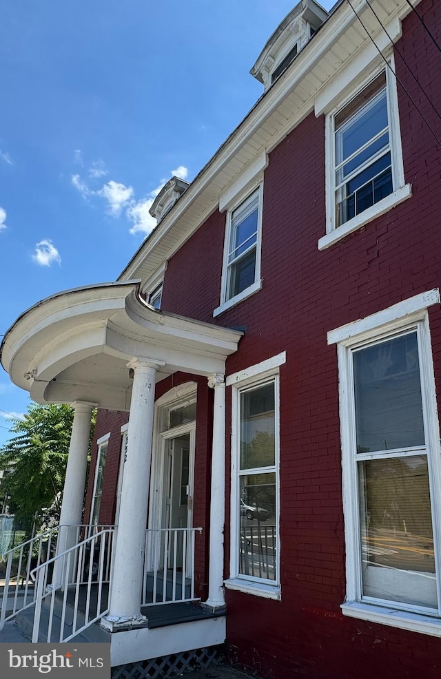 view of side of home with covered porch