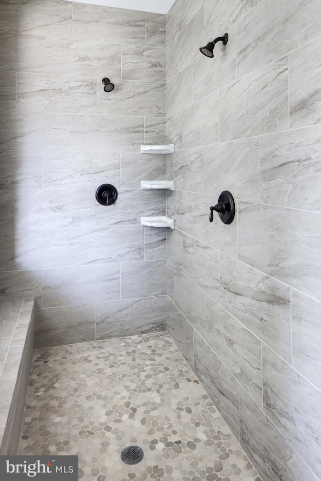 bathroom with tiled shower