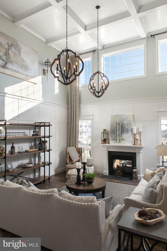 living room with hardwood / wood-style floors, coffered ceiling, a multi sided fireplace, and a healthy amount of sunlight