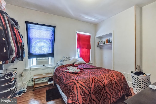 bedroom with a closet and dark hardwood / wood-style floors