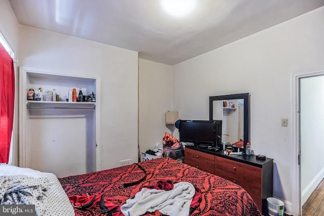 bedroom with wood-type flooring