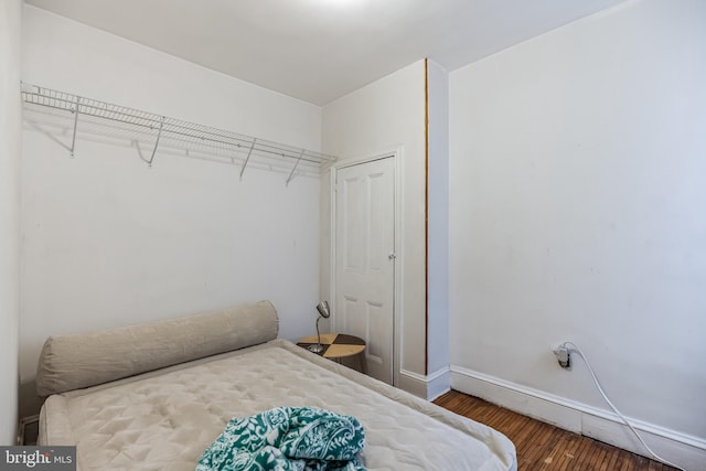 bedroom with dark wood-type flooring