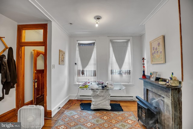 dining area with crown molding, a baseboard radiator, and light hardwood / wood-style flooring