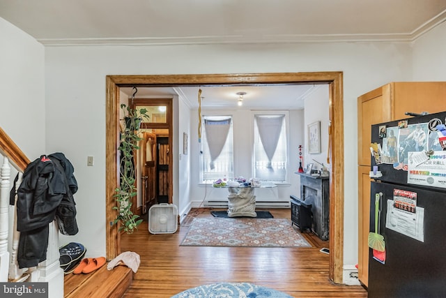 interior space featuring crown molding and hardwood / wood-style floors