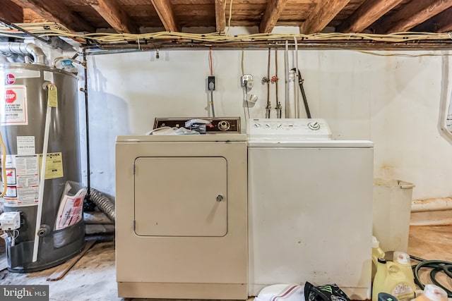 laundry room with gas water heater and washing machine and dryer