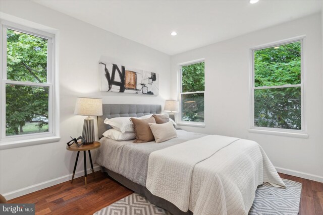 bedroom with dark wood-type flooring