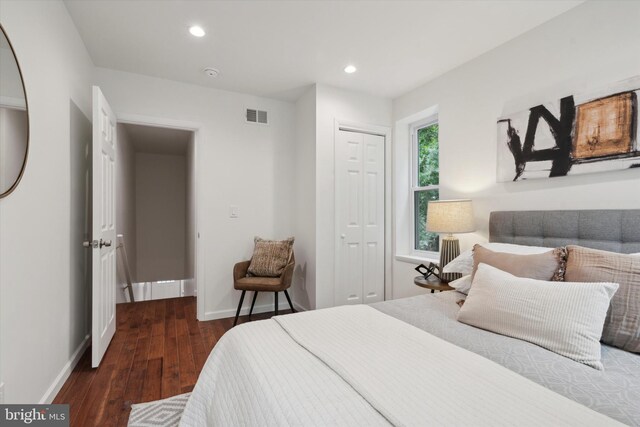 bedroom featuring dark hardwood / wood-style floors and a closet