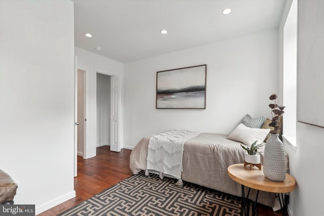 bedroom with dark hardwood / wood-style flooring