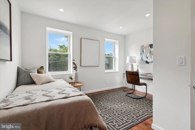 bedroom with dark wood-type flooring