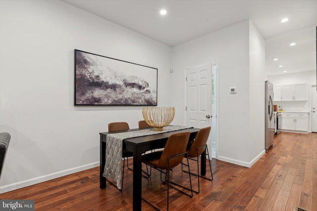 dining room with dark hardwood / wood-style flooring