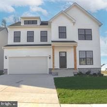 view of front of property with a garage and a front lawn