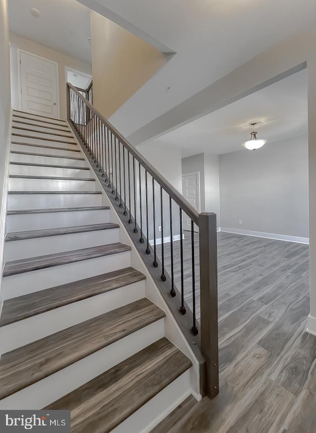 staircase featuring hardwood / wood-style flooring