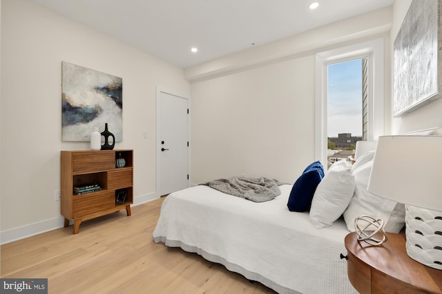 bedroom featuring light hardwood / wood-style flooring and multiple windows