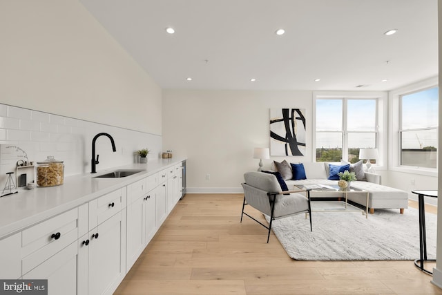 living room with sink and light wood-type flooring