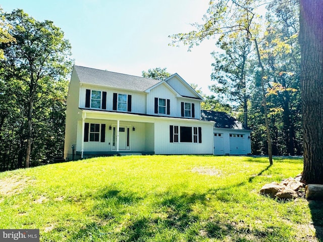 view of front facade featuring a garage, covered porch, and a front lawn