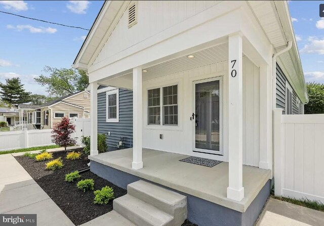 view of exterior entry featuring a porch