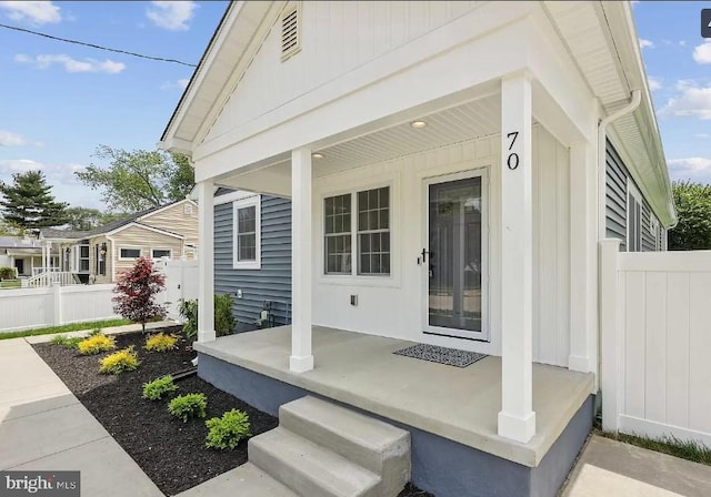 view of patio / terrace with a porch and fence