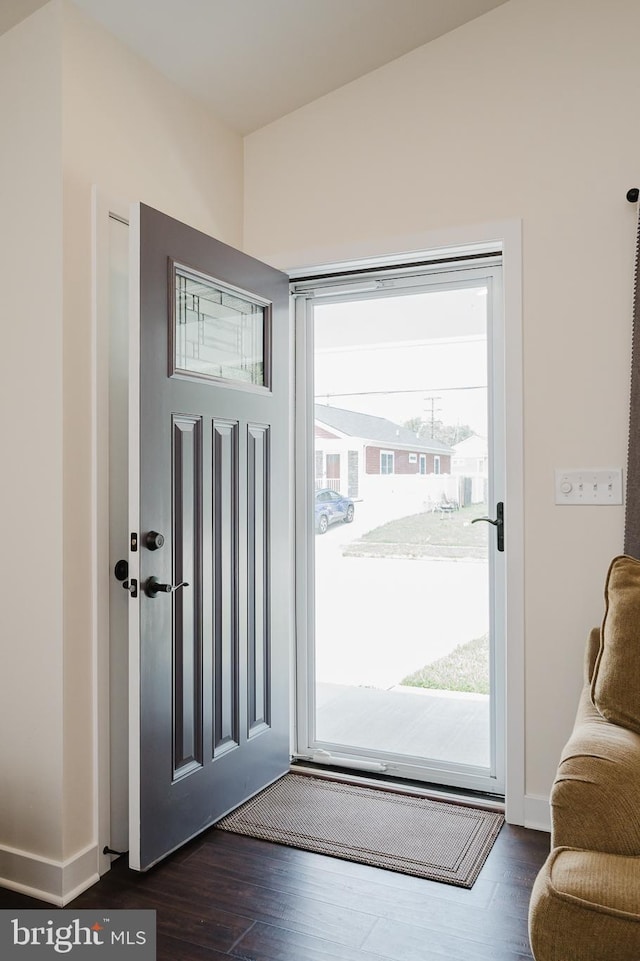 doorway to outside featuring dark wood-style floors and baseboards