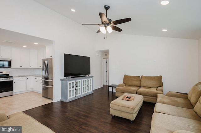 living area with baseboards, light wood-style flooring, recessed lighting, ceiling fan, and vaulted ceiling