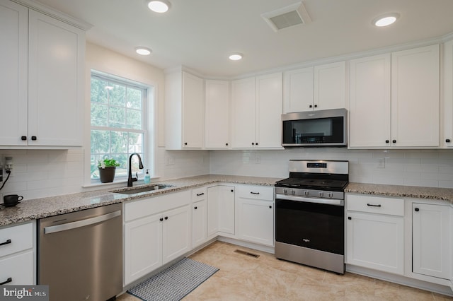 kitchen featuring white cabinetry, visible vents, appliances with stainless steel finishes, and a sink