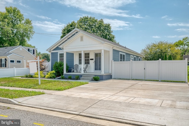 view of front of property with a front yard and a porch