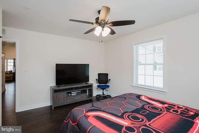 bedroom with baseboards, wood finished floors, and a ceiling fan