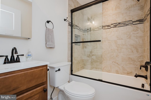 full bathroom with vanity, bath / shower combo with glass door, and toilet