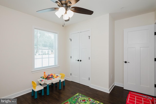 game room with ceiling fan, baseboards, and wood finished floors