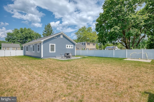 rear view of house with a yard and a patio area