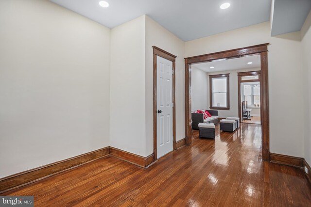 hall with hardwood / wood-style flooring