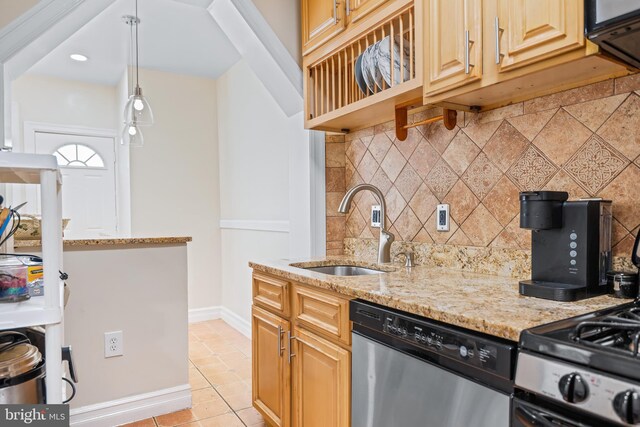 kitchen featuring dishwasher, light stone counters, sink, light tile patterned floors, and decorative backsplash