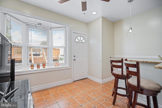 entryway with light tile patterned floors and ceiling fan