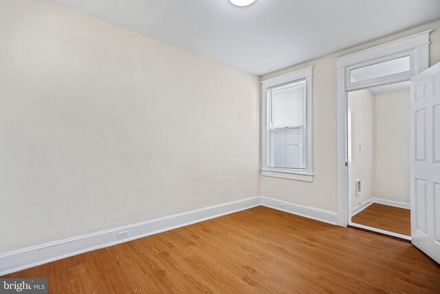 unfurnished bedroom featuring hardwood / wood-style flooring and a closet