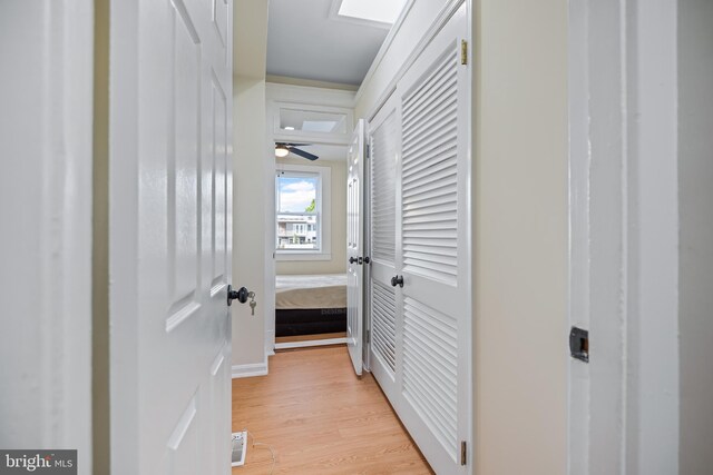 corridor with light wood-type flooring