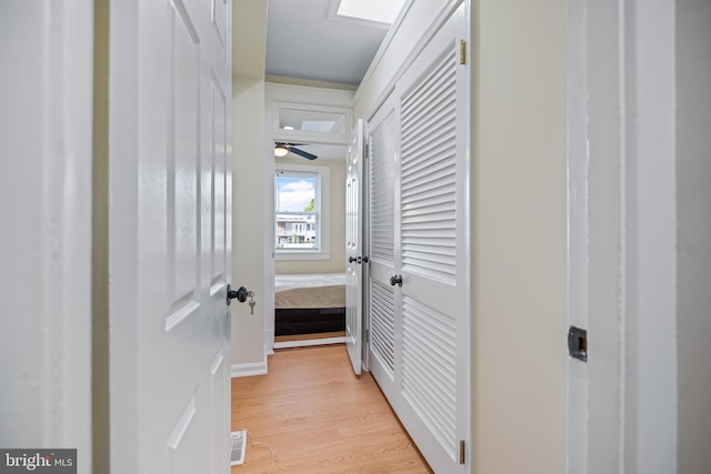 hallway with light hardwood / wood-style floors